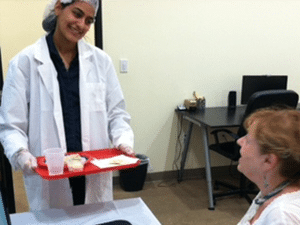 woman holding a tray of items for taste testers